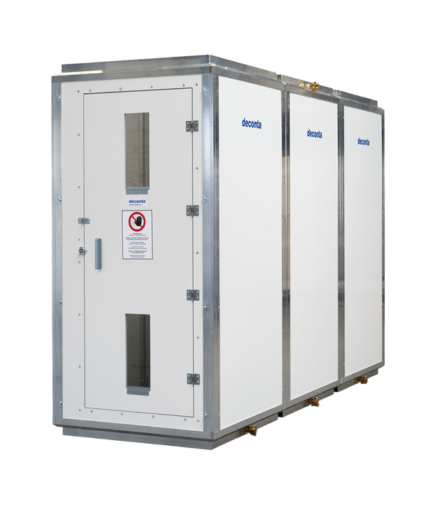 A multi-chamber deconta decontamination unit with a white exterior and metal frame.