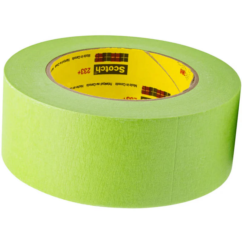 A roll of bright green 3M Scotch 233+ premium automotive masking tape lying flat on a white background.