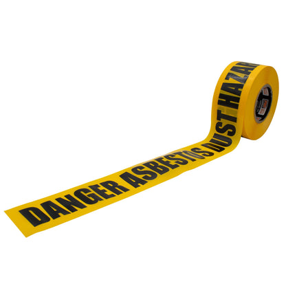 A roll of yellow Pro Safety Gear barricade tape unrolled to show "DANGER ASBESTOS DUST HAZARD" printed in bold black letters on a white background.