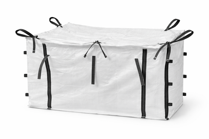 A large white woven skip bag with a top flap closure and multiple black strap handles along the edges.