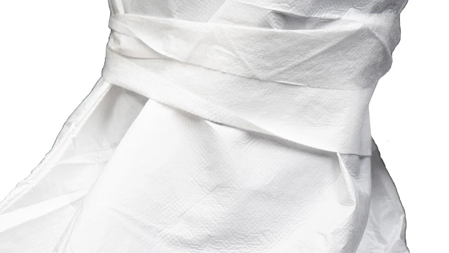 A close-up view of the white fabric tie or closure mechanism on a piece of protective garment.